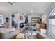 Open living room with gray couches and views into kitchen and dining areas at 1030 Phorus Rd Rd, Venice, FL 34293