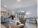 Light and airy living room with gray couches and large windows at 1030 Phorus Rd Rd, Venice, FL 34293