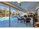 Inviting pool area with covered patio and dining furniture at 1030 Phorus Rd Rd, Venice, FL 34293