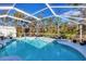 Relaxing screened-in pool area with lounge chairs at 1030 Phorus Rd Rd, Venice, FL 34293
