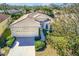 Single-Gathering home with tile roof, driveway, and lush landscaping at 106 Corte Del Asolo, Venice, FL 34285