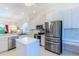 Spacious kitchen with island, stainless steel appliances, and white cabinets at 106 Corte Del Asolo, Venice, FL 34285