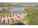 An aerial perspective highlights homes situated around a scenic lake, bordered by lush vegetation at 10637 Corkwood Ct, Venice, FL 34293