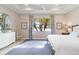 Serene bedroom showcasing trey ceilings, an oversized window, soft blue accents, and tile floors at 10637 Corkwood Ct, Venice, FL 34293