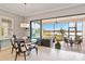 Bright breakfast nook featuring a round table and chairs, with sliding doors to a screened-in patio overlooking a lake at 10637 Corkwood Ct, Venice, FL 34293