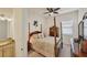 Guest bedroom with a post bed, dresser, and ceiling fan at 10829 Whisk Fern Dr, Venice, FL 34293