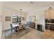 Bright dining room with wooden table, wine cooler, and view to backyard at 10829 Whisk Fern Dr, Venice, FL 34293