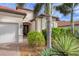 Front view of house showcasing entryway and landscaping at 10829 Whisk Fern Dr, Venice, FL 34293