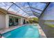 Resort-style pool and spa with screened-in patio and seating at 10829 Whisk Fern Dr, Venice, FL 34293