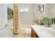 Clean bathroom with tub shower and wood vanity at 11394 Dancing River Dr, Venice, FL 34292