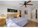 King-size bed in bright bedroom with hardwood flooring and ceiling fan at 11449 Claggett Ave, Port Charlotte, FL 33981