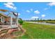 Waterfront backyard with screened patio and lush lawn at 1151 Creek Nine Dr, North Port, FL 34291