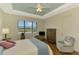 Main bedroom with wood floors and ceiling fan at 1151 Creek Nine Dr, North Port, FL 34291