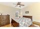 Spacious bedroom with wood furniture and a ceiling fan at 1151 Creek Nine Dr, North Port, FL 34291