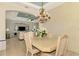 Formal dining room with chandelier and views to the living room at 1151 Creek Nine Dr, North Port, FL 34291