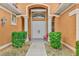 Front entry with double doors, decorative columns, and shrubs at 1151 Creek Nine Dr, North Port, FL 34291