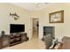 Home office with TV, desk, and view into another room at 1151 Creek Nine Dr, North Port, FL 34291