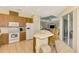 Open kitchen with breakfast bar, wood cabinets, and views of the living and dining areas at 1151 Creek Nine Dr, North Port, FL 34291