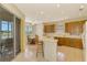 Kitchen boasts ample cabinetry, an island with seating, and views to the screened patio and golf course at 1151 Creek Nine Dr, North Port, FL 34291