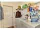 Laundry room with washer, dryer, and storage shelves at 1151 Creek Nine Dr, North Port, FL 34291