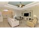 Bright living room features a neutral color palette, comfy seating, and built-in entertainment center at 1151 Creek Nine Dr, North Port, FL 34291