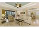 Spacious living area showcasing comfortable seating, an open floor plan, and access to a relaxing screened patio at 1151 Creek Nine Dr, North Port, FL 34291