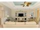 Living room with large TV, comfy seating, and built-in shelving at 1151 Creek Nine Dr, North Port, FL 34291