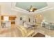 Open living room with views into kitchen and dining areas, featuring comfortable seating and a neutral color scheme at 1151 Creek Nine Dr, North Port, FL 34291