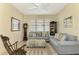 Cozy sitting room featuring a comfy sofa, ottoman, and rocking chair at 1151 Creek Nine Dr, North Port, FL 34291