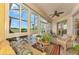 Sunroom with wicker furniture and view of the backyard at 1151 Creek Nine Dr, North Port, FL 34291