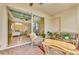 Bright sunroom with wicker furniture and view of living room at 1151 Creek Nine Dr, North Port, FL 34291