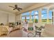 Relaxing sunroom with wicker furniture and view of water at 1151 Creek Nine Dr, North Port, FL 34291