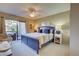 Main bedroom with a king-size bed and access to a private balcony at 1174 Bird Bay Way # 107, Venice, FL 34285