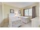 Guest bedroom with two twin beds, updated decor, and ample closet space at 1174 Bird Bay Way # 107, Venice, FL 34285