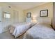 Guest bedroom with two twin beds, updated decor, and ample closet space at 1174 Bird Bay Way # 107, Venice, FL 34285