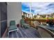 Private deck overlooking a tranquil lake, featuring lounge chairs and a small table at 1174 Bird Bay Way # 107, Venice, FL 34285