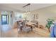 Dining area with wood table and chairs, near kitchen at 1174 Bird Bay Way # 107, Venice, FL 34285