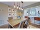Light and bright dining room with wood table and seating for six at 1174 Bird Bay Way # 107, Venice, FL 34285