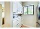 White kitchen cabinets, quartz countertops, and modern appliances at 1174 Bird Bay Way # 107, Venice, FL 34285