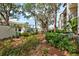 Landscaped grounds with mature trees and walkway at 1174 Bird Bay Way # 107, Venice, FL 34285