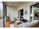 Screened patio with wicker furniture and a built-in fireplace, creating a warm ambiance at 1174 Bird Bay Way # 107, Venice, FL 34285