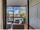 Bright sunroom with wicker furniture and view of the water at 1174 Bird Bay Way # 107, Venice, FL 34285