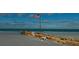 Beachfront view with old wooden structure at 126 Venice East Blvd, Venice, FL 34293