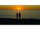 Couple silhouetted against a vibrant sunset at 126 Venice East Blvd, Venice, FL 34293