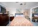 Bedroom with king-size bed, dresser, and ceiling fan at 126 Venice East Blvd, Venice, FL 34293