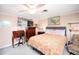 Bedroom with a king-size bed, dresser, and ceiling fan at 126 Venice East Blvd, Venice, FL 34293