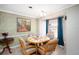 Bright dining room features a round table with four chairs and a large window at 126 Venice East Blvd, Venice, FL 34293