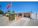 House with a brick walkway, attached garage, and American flag at 126 Venice East Blvd, Venice, FL 34293