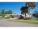 Ranch-style home with rock exterior and mature landscaping at 126 Venice East Blvd, Venice, FL 34293