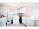 Laundry room with washer, dryer, cabinets, and mini-fridge at 126 Venice East Blvd, Venice, FL 34293